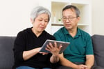 Asian old couple using tablet