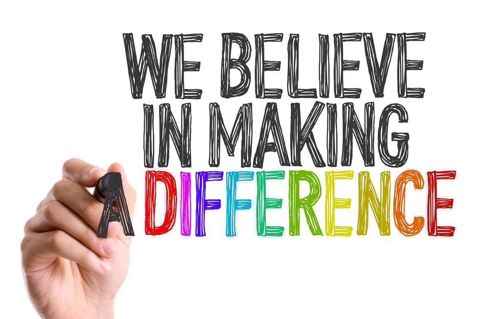 Hand with marker writing We Believe in Making a Difference Hand with marker writing We Believe in Making a Difference
