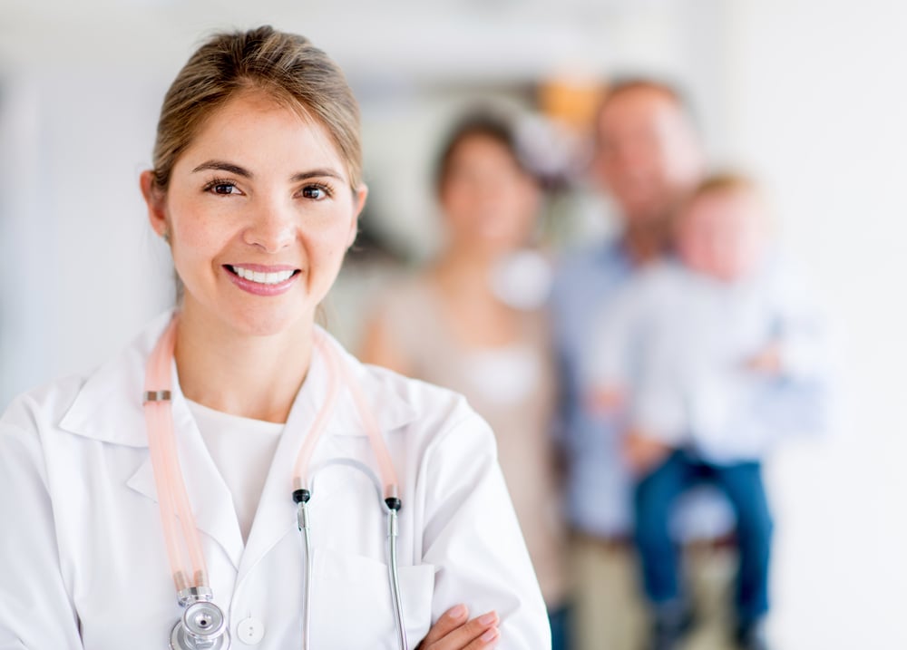 Happy family doctor at the hospital looking happy